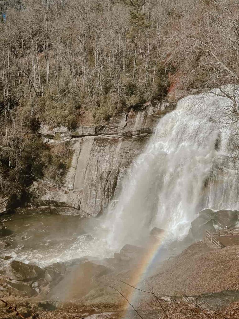 Picture of a waterfall with a rainbow in the mist.