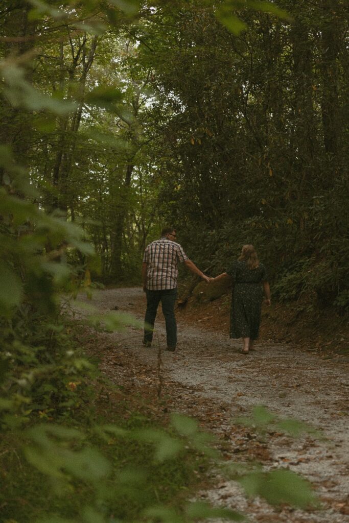 Man and woman walking down path at Sunset Rock in Highlands, North Carolina.