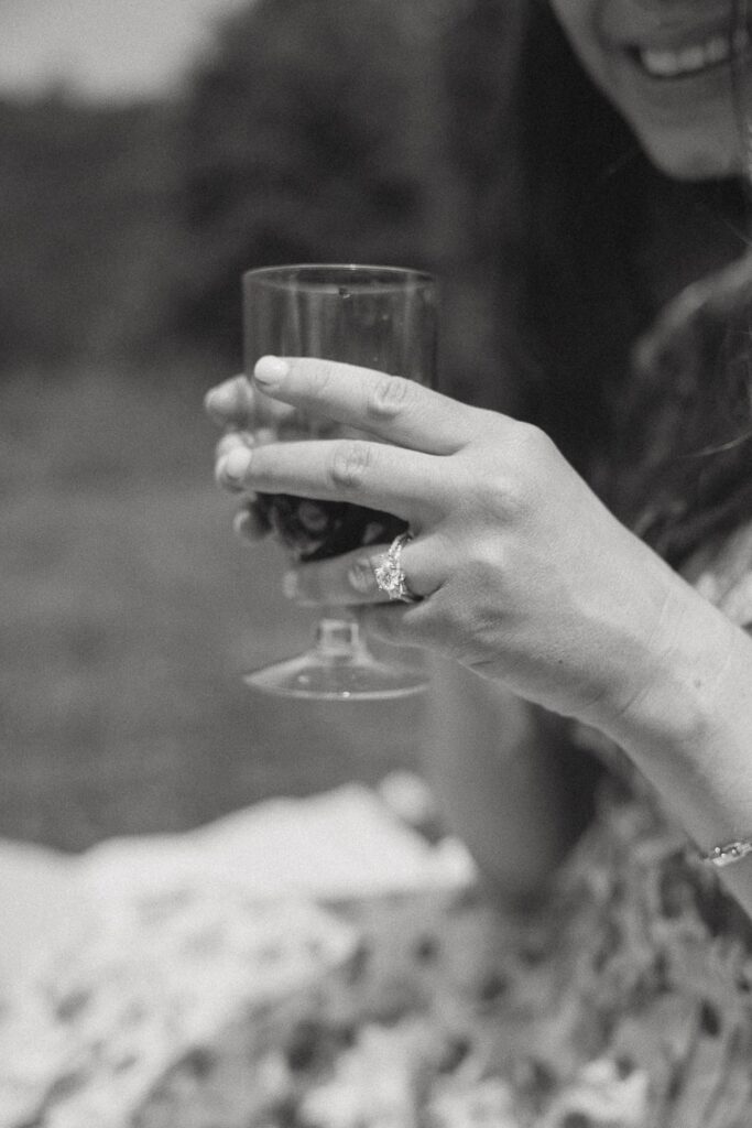 Close up of a woman holding a wine glass.