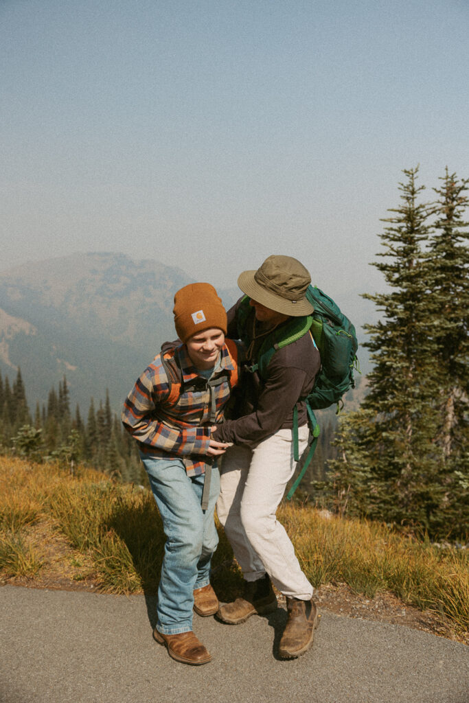 man and kid playing on trail in washington.