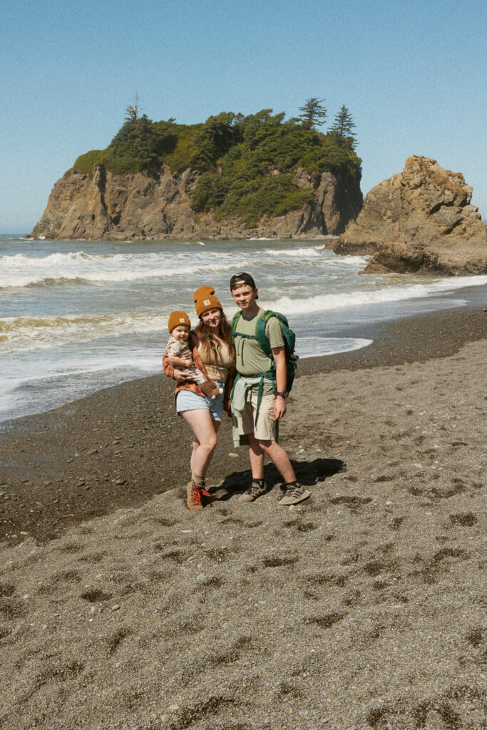 woman with two kids standing on ruby beach in washington. 