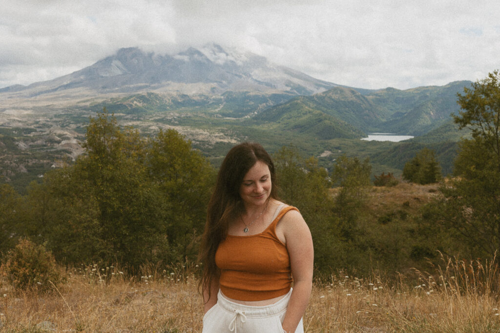 woman standing in front of mt st helens.