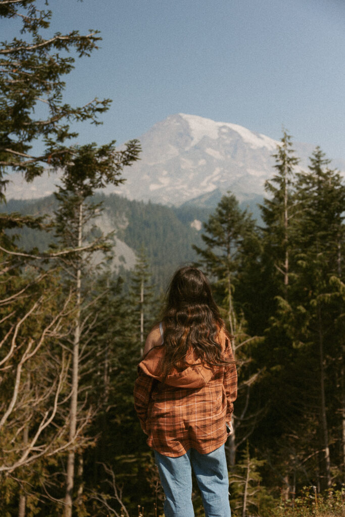 woman standing and looking at mt rainier.
