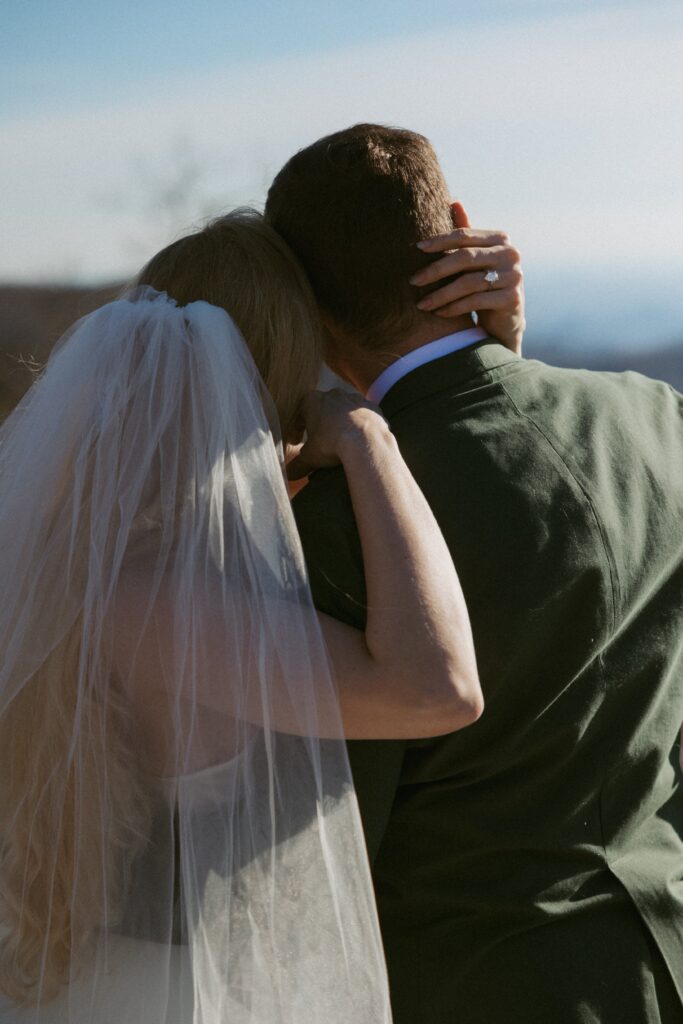 Man and woman hugging during elopement at Sassafras Mountain.