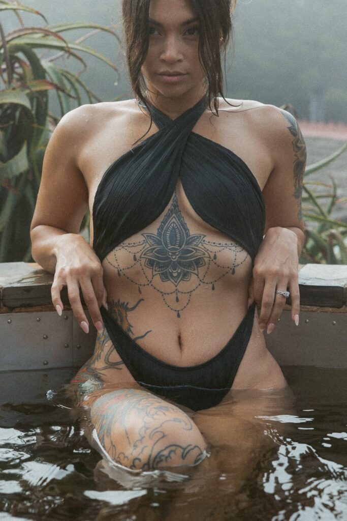 Woman with tattoos in a bathing suit. 