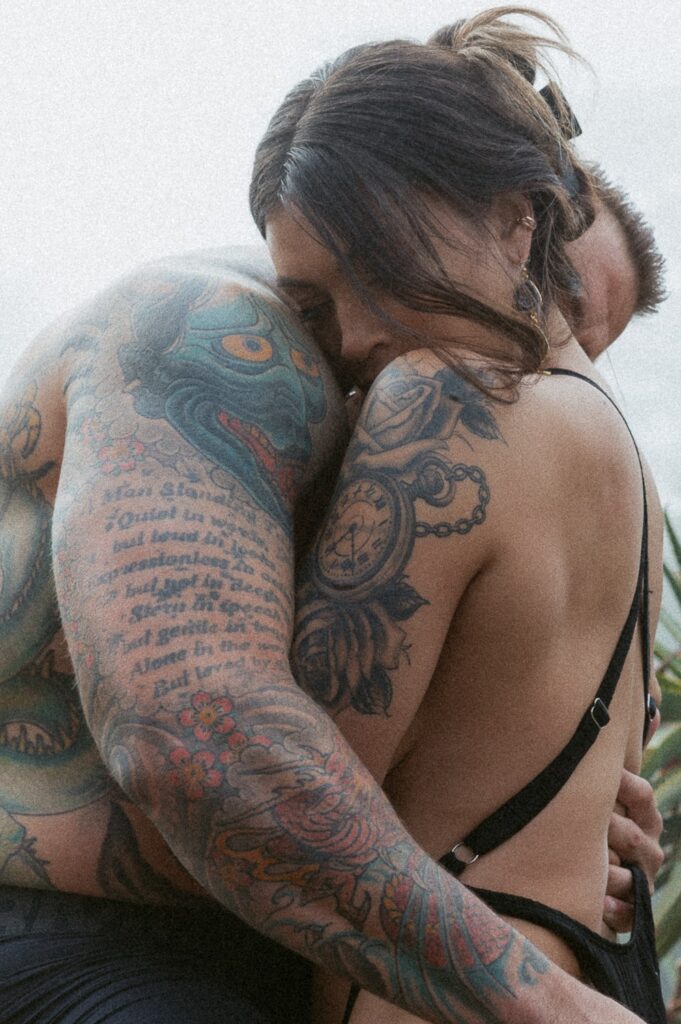Close up of man and woman hugging while in a hot tub. 