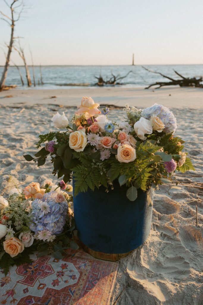 Colorful floral arrangements on the beach. 