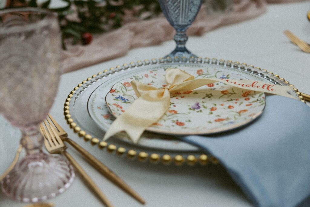 Thrifted table scape at a wedding with a yellow bow.