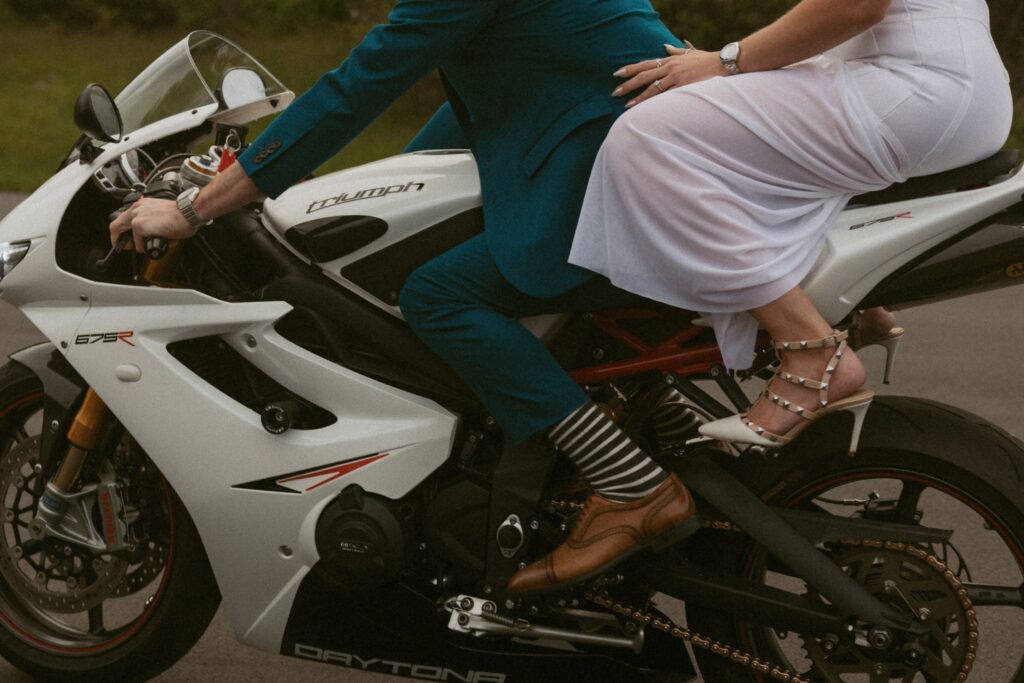 Close up of man and woman's feet on motorcycle.