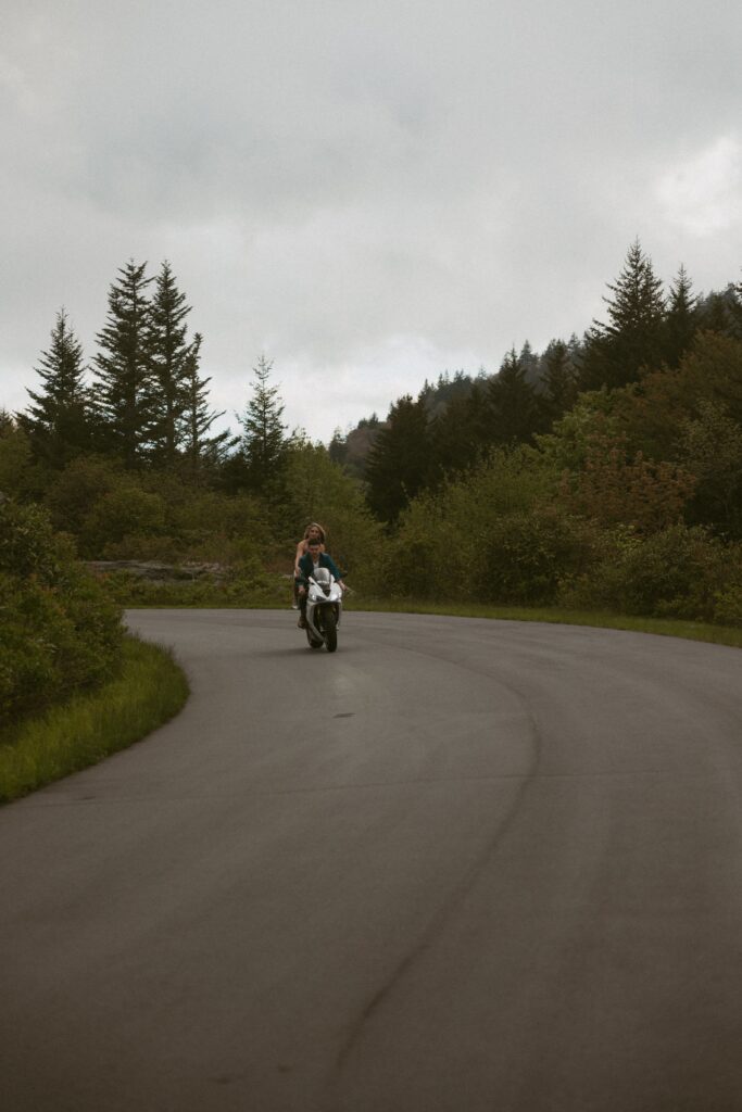 Man and woman riding a motorcycle.