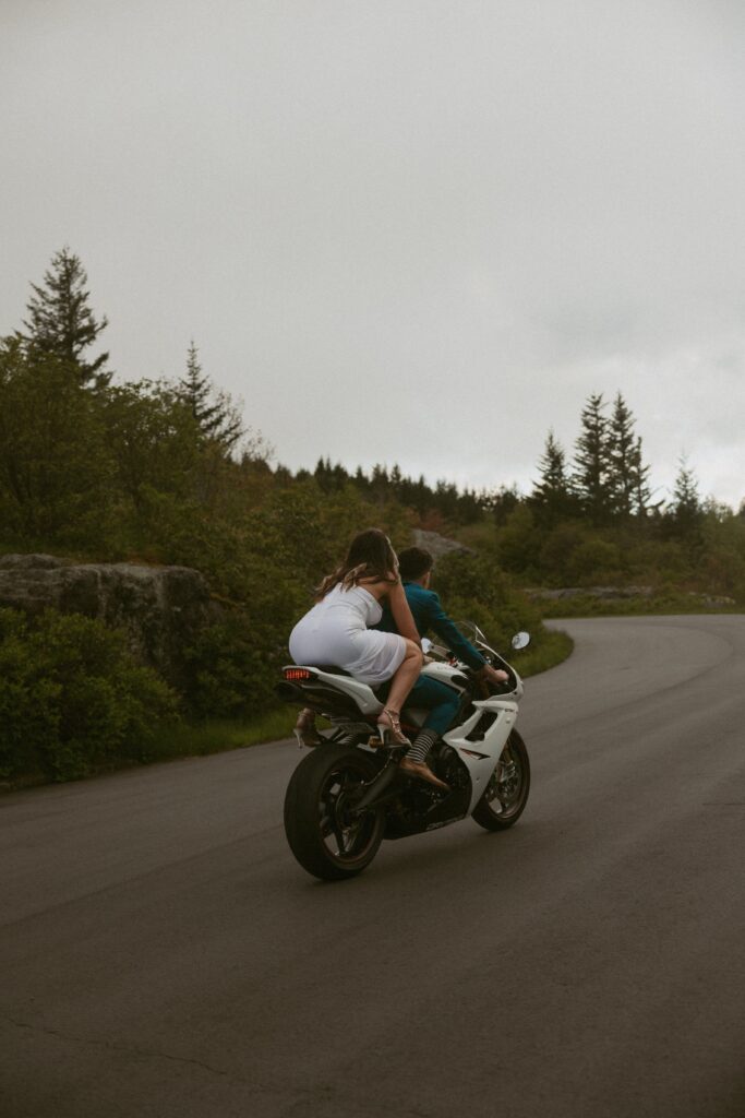 Man and woman riding a motorcycle.