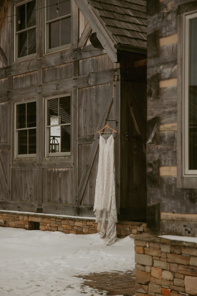 wedding dress hanging on the front of cabin.