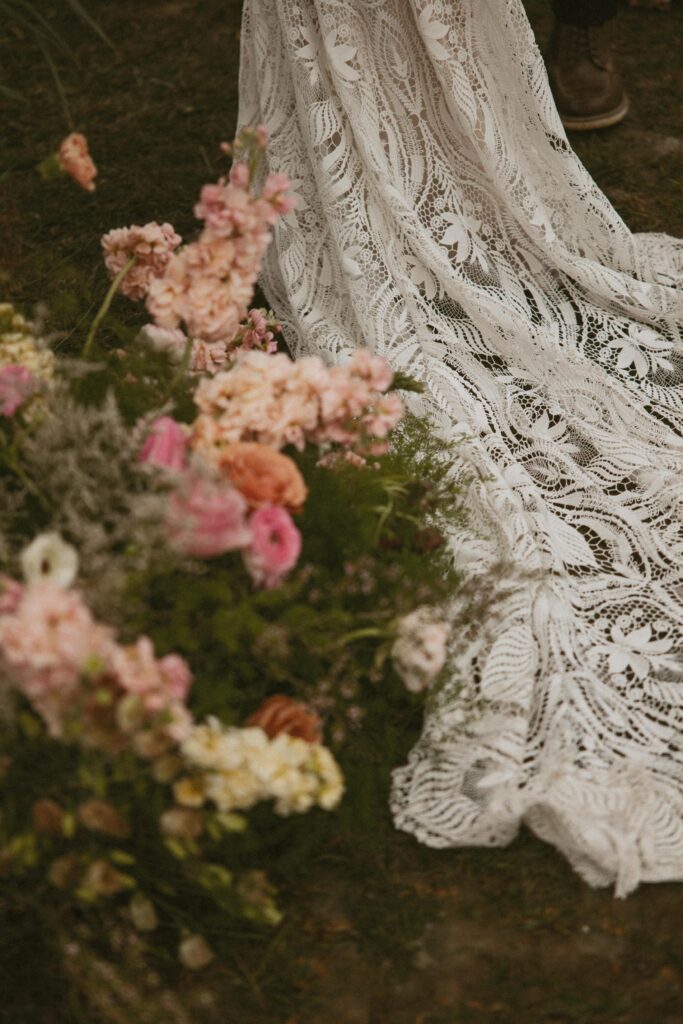 womans wedding dress train with flowers.