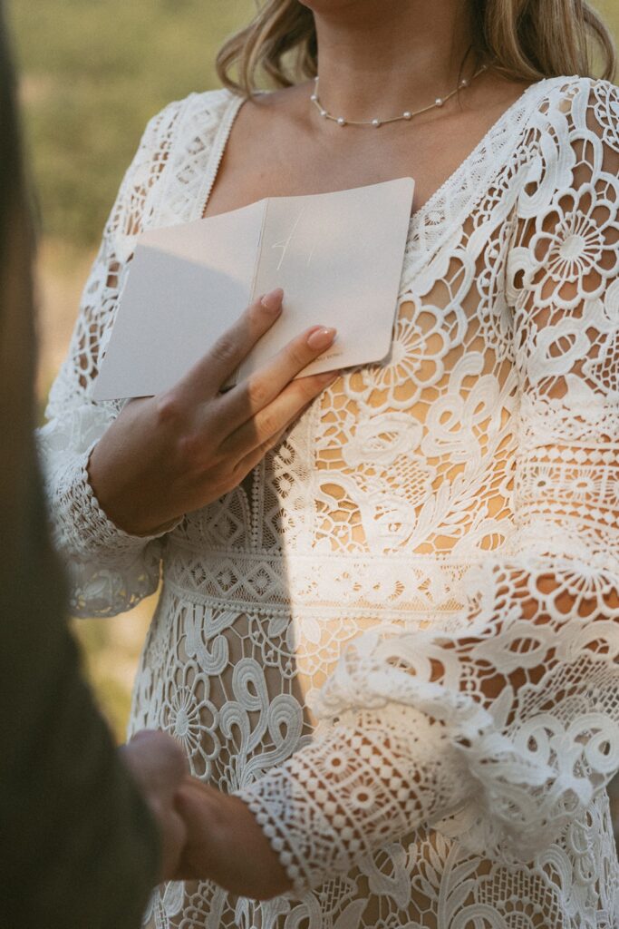 Man and woman in wedding attire reading vows at the main overlook in Cloudland Canyon State park.