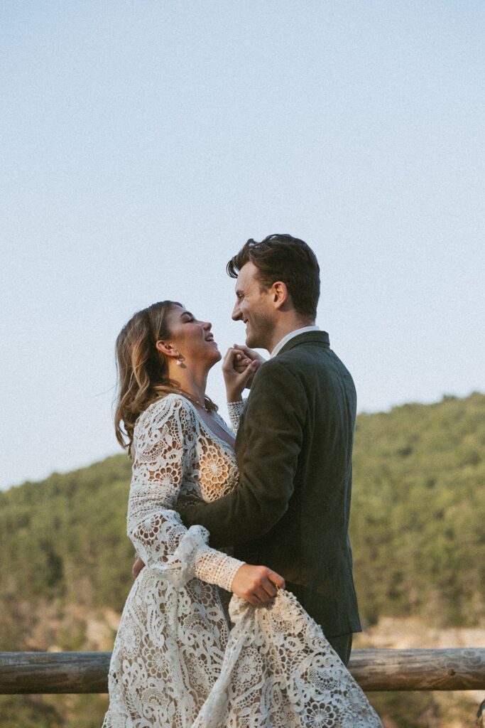 Man and woman in wedding attire dancing at the main overlook in Cloudland Canyon State park.