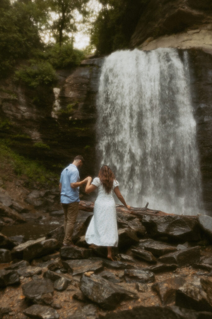 Man and woman standing in front of Looking Glass Falls.