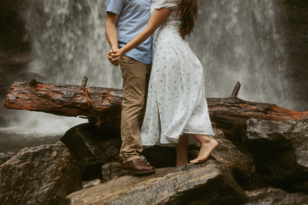 Man and woman standing in front of Looking Glass Falls.