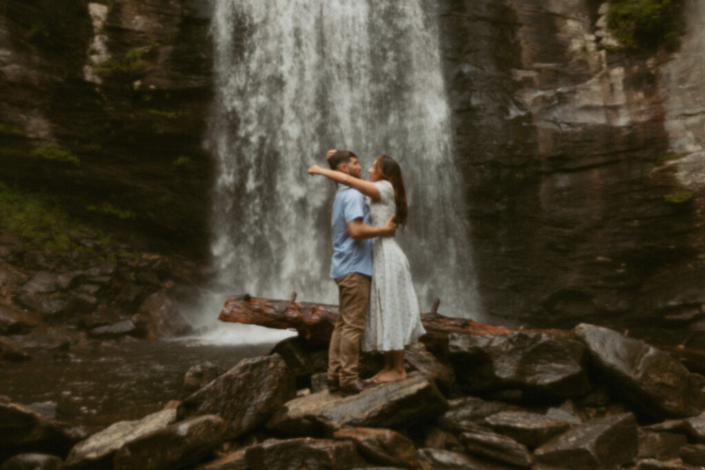 Man and woman standing in front of Looking Glass Falls.