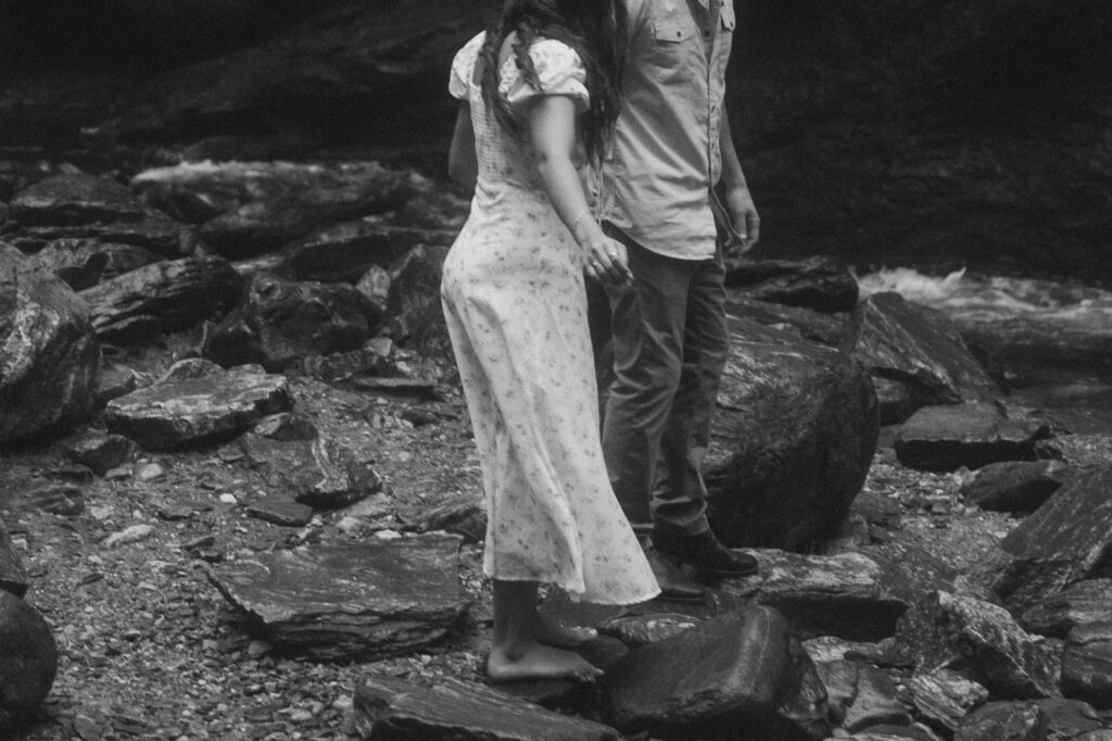 Man and woman standing in front of Looking Glass Falls.