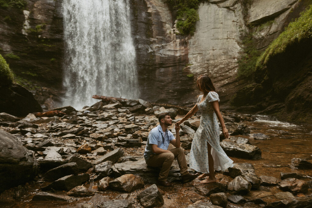 Man and woman in front of Looking Glass Falls.