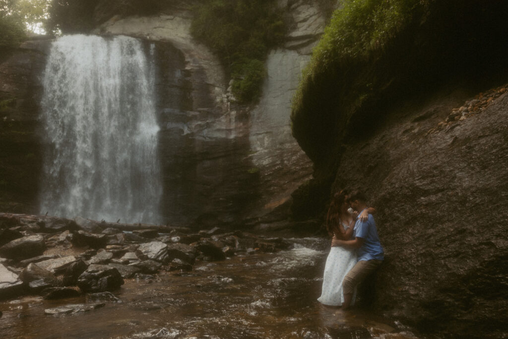 Man and woman standing in front of Looking Glass Falls.