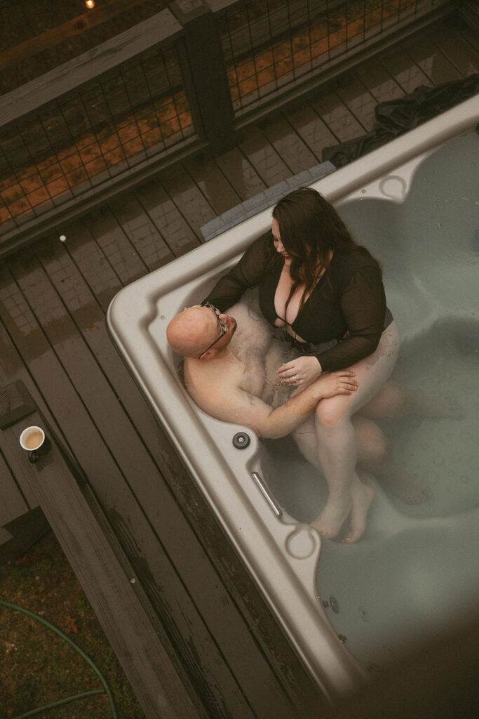 Man and woman in hot tub in the north georgia mountains the day after their elopement