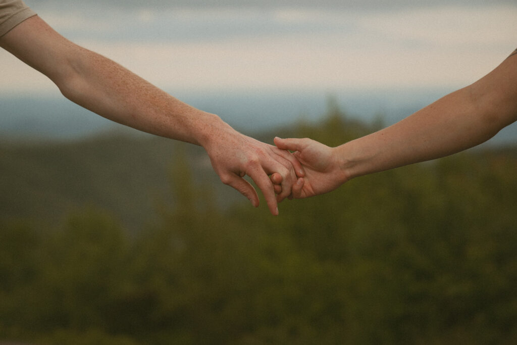 Man and woman holding hands at Sassafras Mountain.