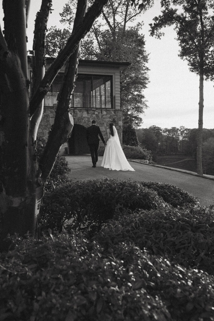 husband and wife holding hands and walking away