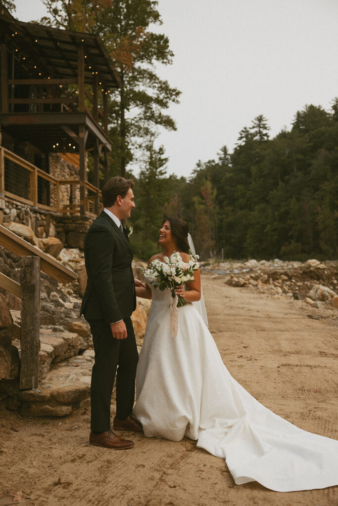 Husband and wife laughing at each other on their wedding day at Brown Mountain Beach Resort.