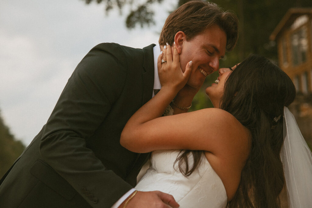 Bride and groom smiling and about to kiss.