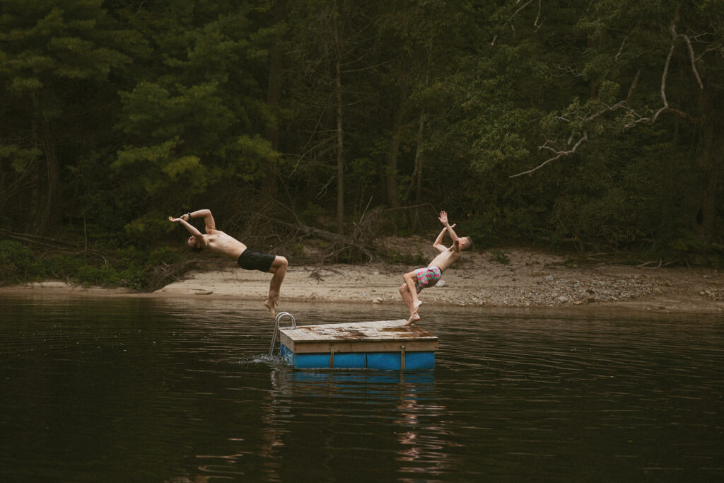 Guests doing backflips into wilson creek at Brown mOuntain beach resort in north carolina.