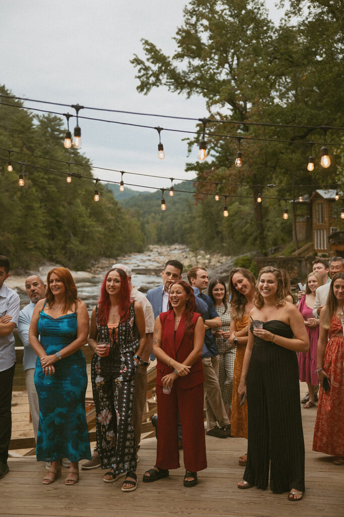Guests laughing under string lights at Brown Mountain Beach Resort.