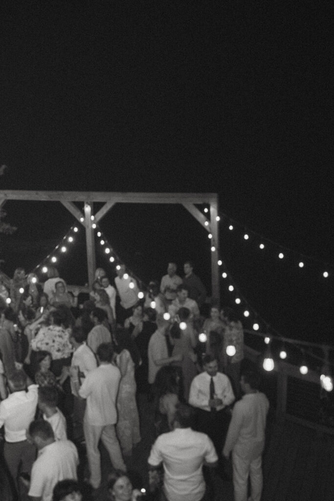 Guests dancing under string lights at Brown Mountain Beach Resort.