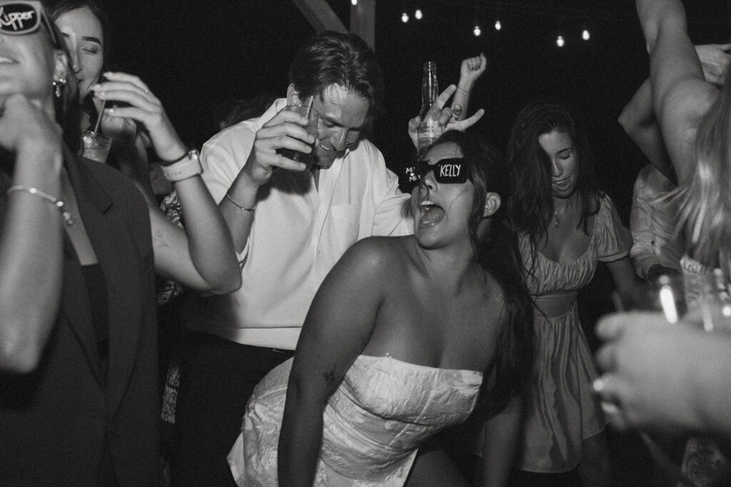 bride and groom dancing and singing surrounded by their guests at brown mountain beach resort.