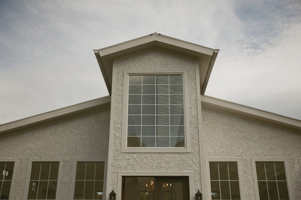 Front view of Luxe Glass House wedding venue during daylight.