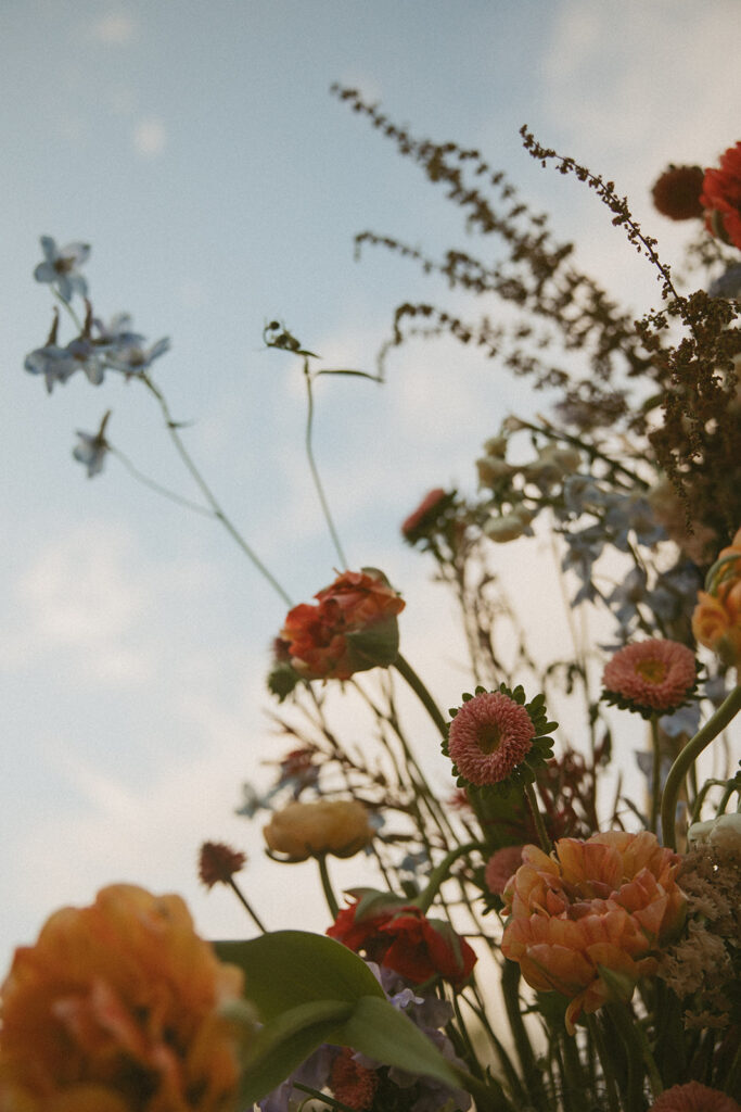 Floral arrangements displayed at Luxe Glass House wedding venue.